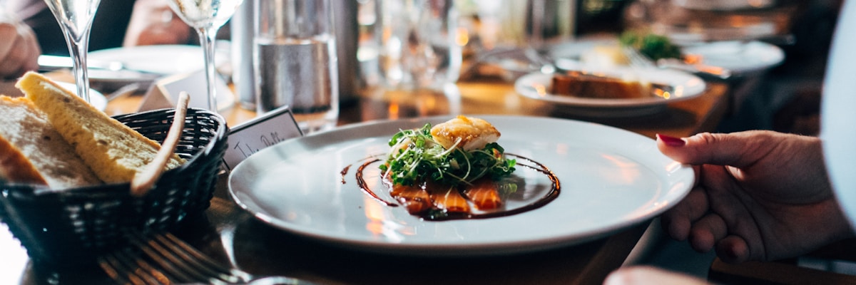 A beautifully plated dinner on a candlelit restaurant table