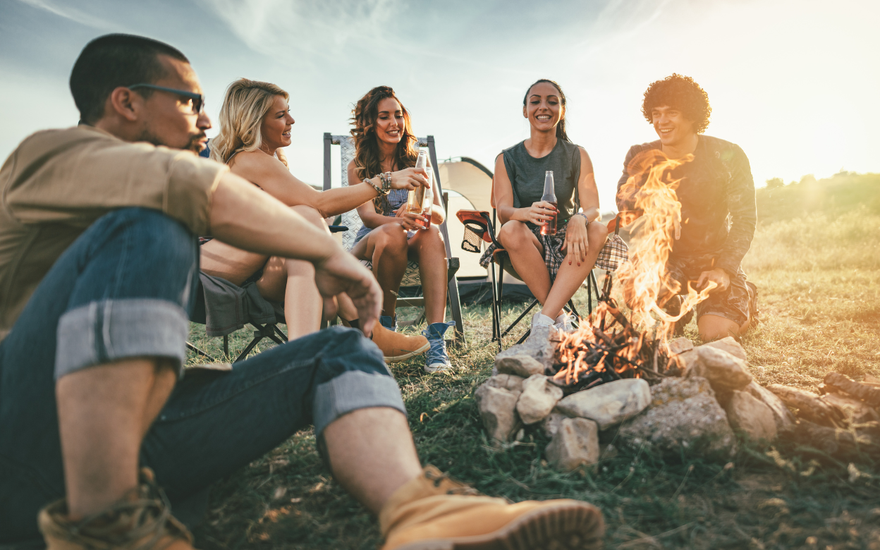Large group outdoors, laughing and bonding.