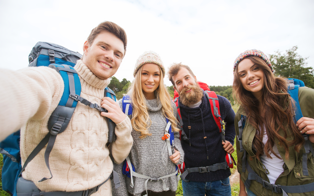 Four friends taking a selfie while hiking