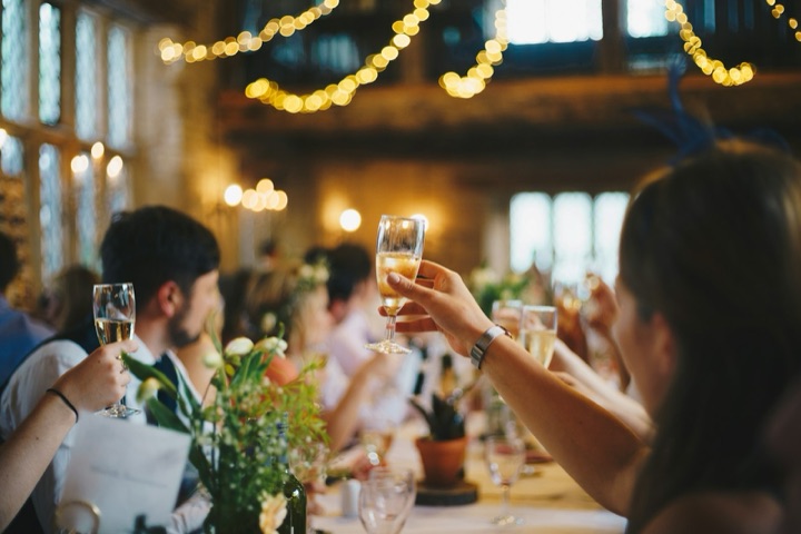 People raising glasses over dinner